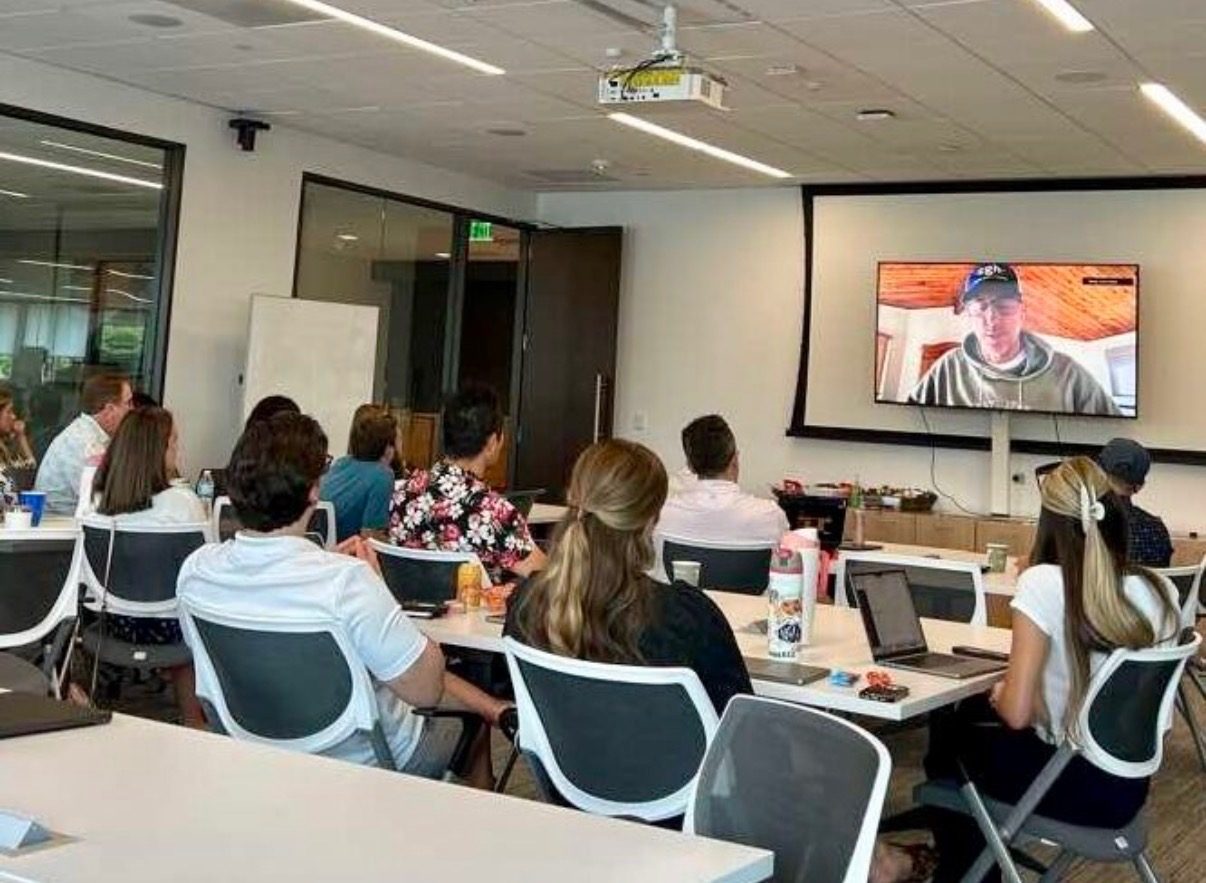 Case Status staff watching Travis on the big screen during Summer Sessions